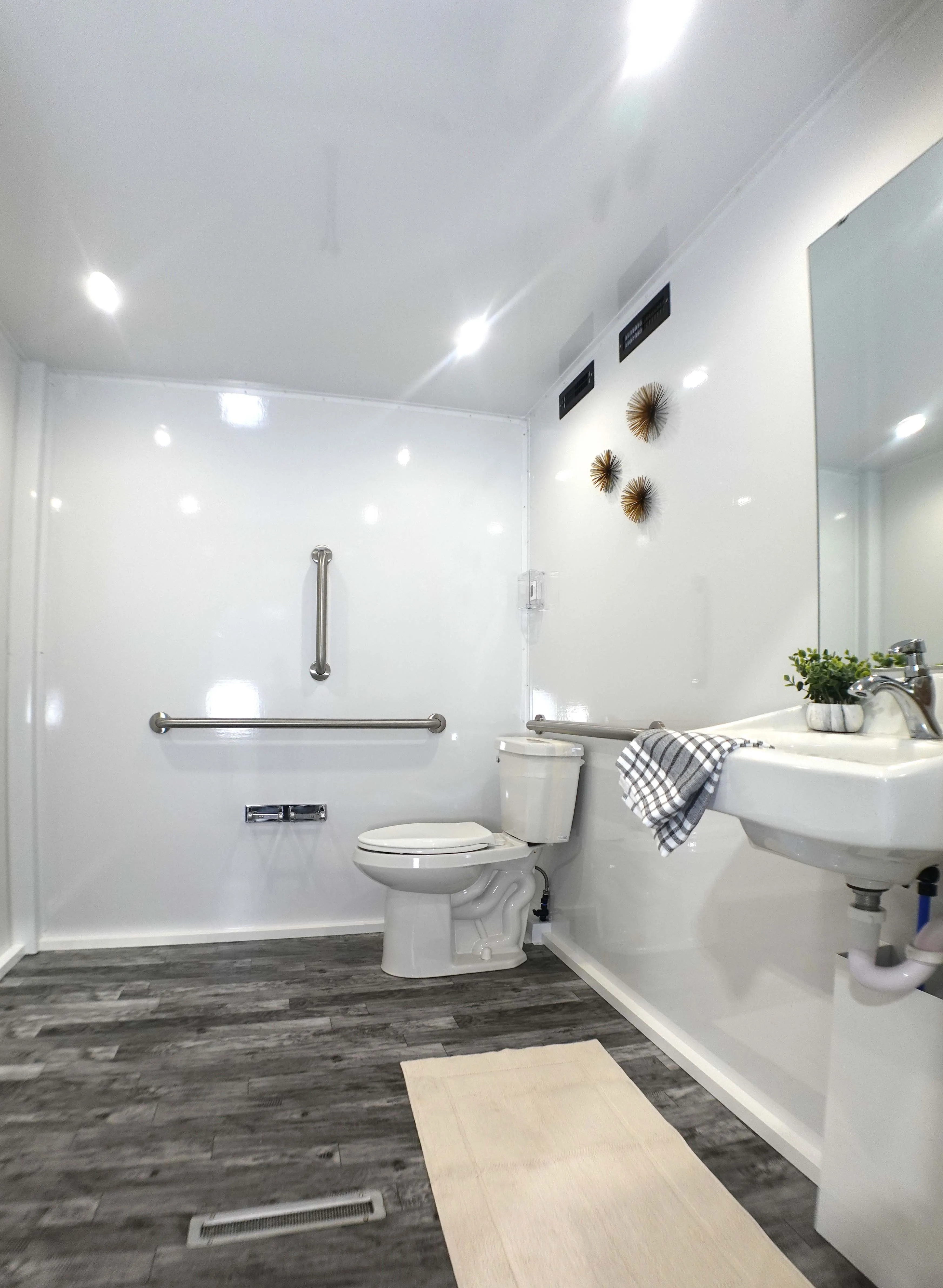 Spacious ADA-compliant restroom with wheelchair accessibility, grab bars, and ample turning radius