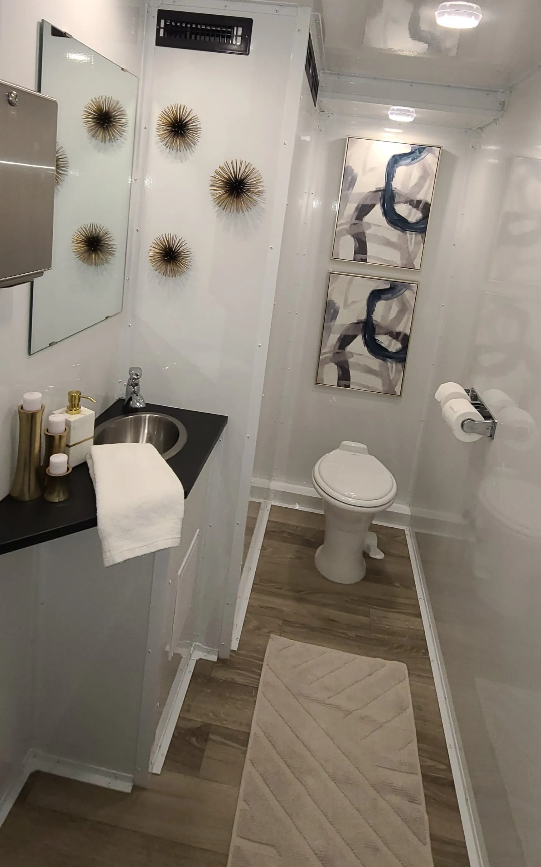 Women's restroom stall with modern fixtures, LED lighting, and premium finishes