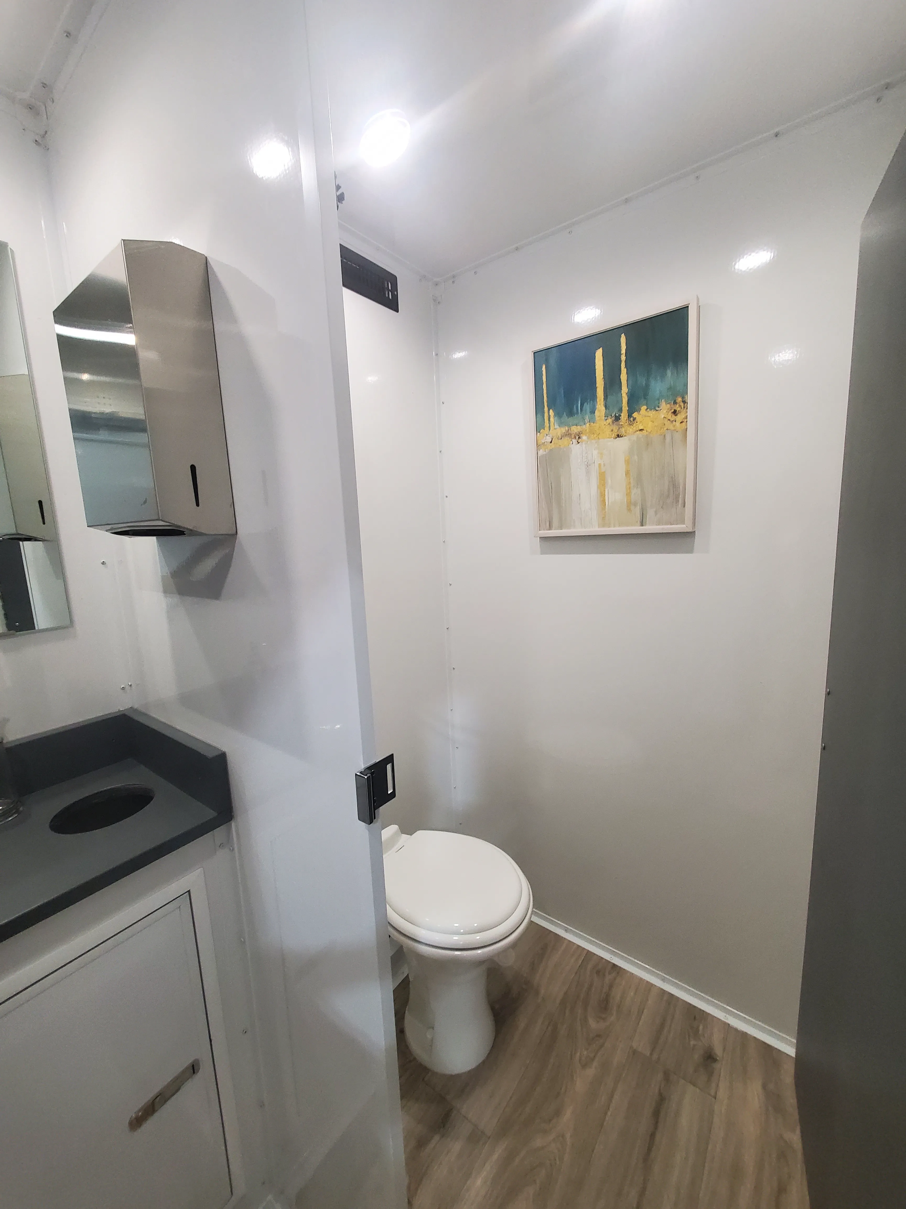 Private restroom stall with premium fixtures, LED lighting, and climate-controlled comfort