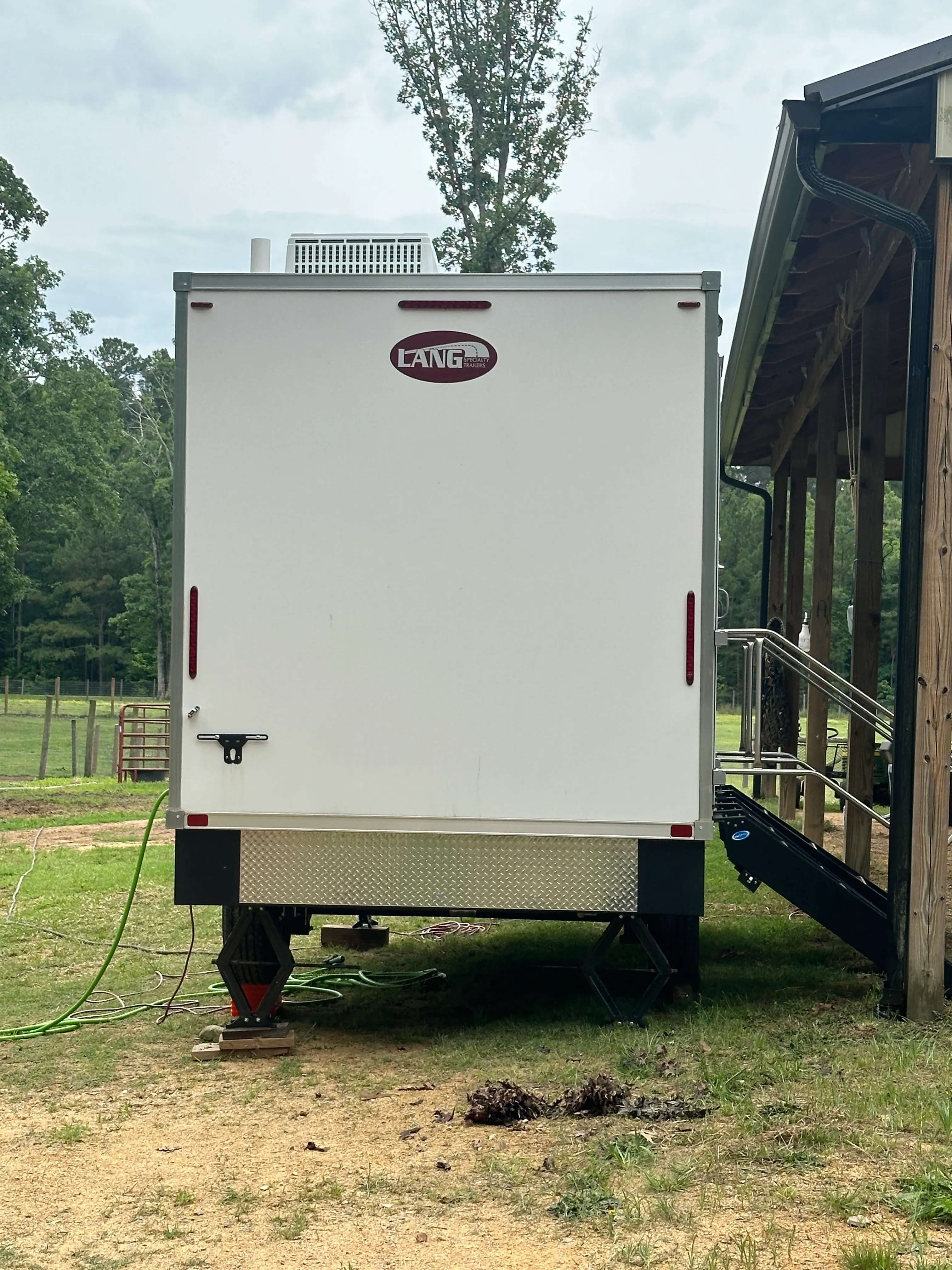 Optimal Placement: Restroom trailer set up next to barn
