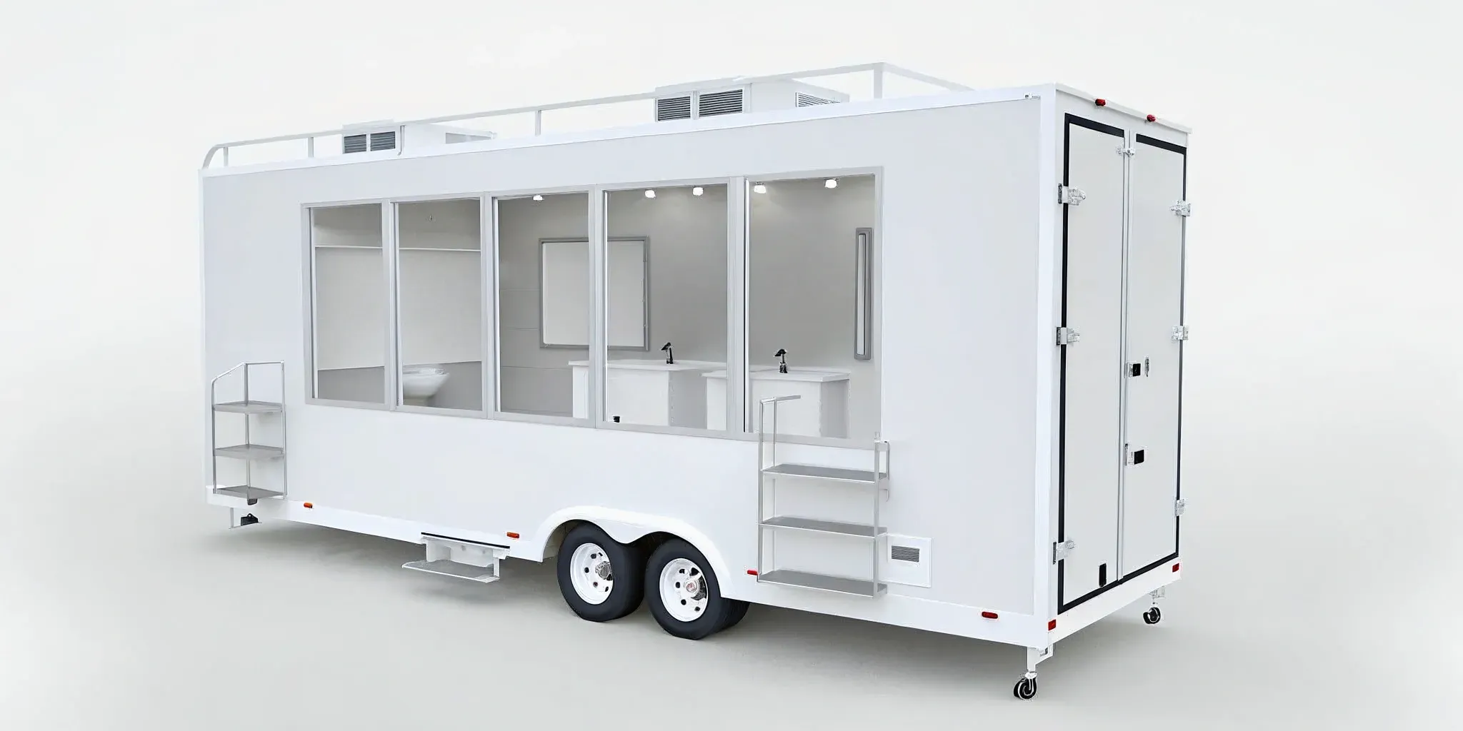 Features included in a luxury restroom trailer rental: modern sinks, vanities, and a spacious interior.